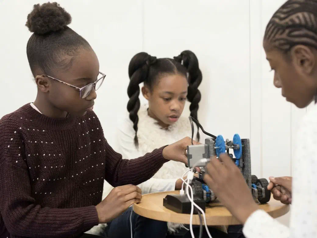 Students building a robotics project in an after-school session